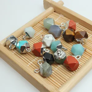 Variety of faceted semi-precious gemstone pendants for DIY jewelry on bamboo tray