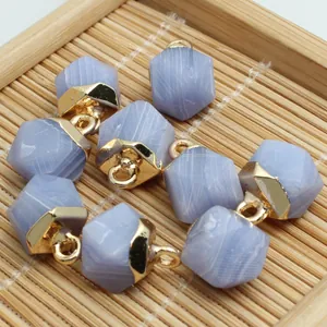Detail of hexagonal faceted blue lace agate pendants with gold loops for jewelry DIY