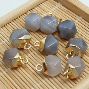 Detail view of faceted grey agate charms with gold loops for DIY jewelry components.