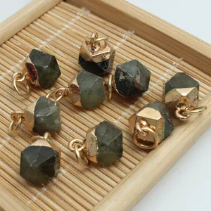 Detailed close-up of irregular cut semi-precious stone pendants on a bamboo mat.