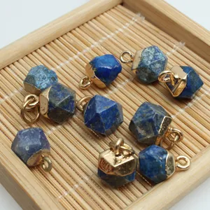 Macro view of irregular faceted lapis blue stone pendants with gold plated metal caps