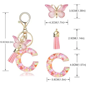 Detailed dimensions of pink butterfly tassel keychain with heart sequins and letter C