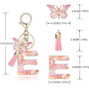 Detail showing dimensions of pink heart sequin letter E keychain with butterfly and tassel