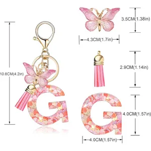 Size details of glitter letter G keychain featuring pink butterfly and tassel charms