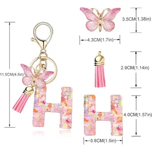 Detailed measurement layout of a pink letter H resin keychain with butterfly and tassel charms