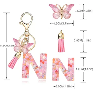 Detailed dimension view of pink heart sequin letter N keychain with butterfly and tassel