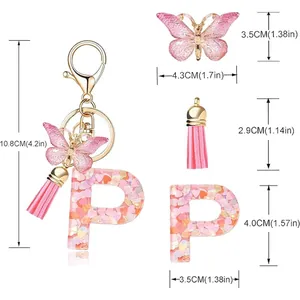 Detail view showing dimensions of butterfly and tassel keychain with heart glitter