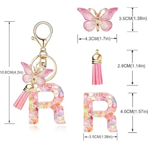 Detail view showing dimensions of pink heart sequin letter R keychain with butterfly