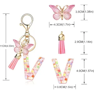 Detail of letter V keychain with heart sequins, pink butterfly, and tassel dimensions