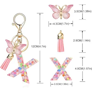 Detailed dimensions of letter X keychain with heart sequins, butterfly, and tassel