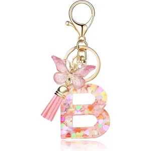 Pink resin letter B keychain with heart sequins, butterfly charm and pink tassel