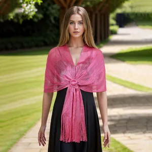Detail view of pink metallic hollow out shawl with fringe and brooch decoration