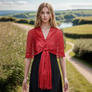 Close-up of red metallic thread hollow shawl featuring a circular buckle and fringe