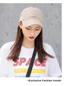 Detailed view of beige breathable mesh baseball cap worn by a female model outdoors