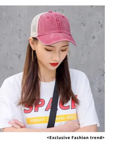 Close-up of pink washed mesh baseball cap worn by model for sun protection