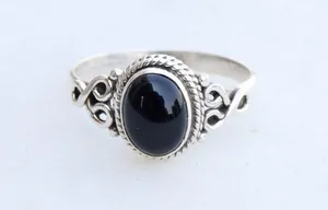 Vintage silver alloy ring with large oval black onyx stone and scrollwork details