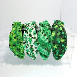 Detail view of St. Patrick's Day knotted headbands with shamrock patterns and beads