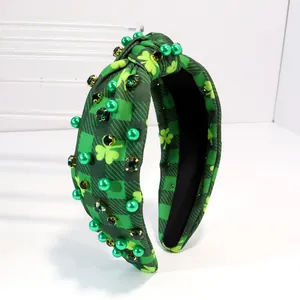 Detail of green shamrock plaid headband with emerald faux gems for St. Patrick's Day.