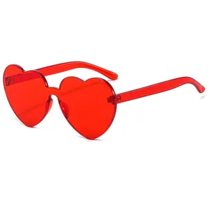 Vibrant red heart-shaped rimless sunglasses with a transparent jelly finish for women