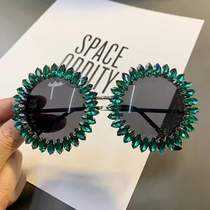 Oversized round sunglasses embellished with green rhinestones for stage parties