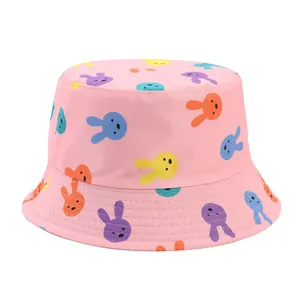 Detailed macro view of pink kids bucket hat featuring colorful cartoon rabbit print patterns