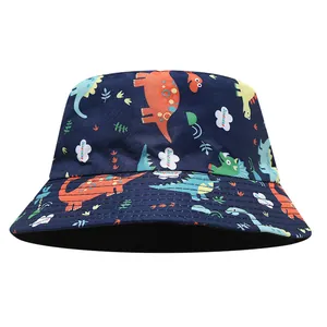 Detail view of a children's reversible bucket hat featuring colorful cartoon dinosaur prints
