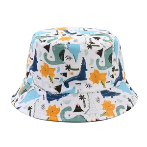 Close-up detail showing the colorful cartoon dinosaur pattern on kids reversible bucket hat