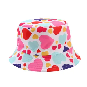 Detailed view of children's white bucket hat featuring a vibrant colorful heart pattern
