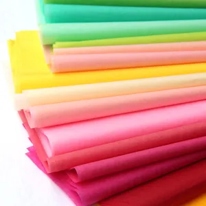 Macro detail view showing layers of vibrant colorful 17g tissue paper for gift wrapping.
