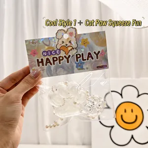 Detailed view of a glittery cat paw squishy toy with pearls in clear packaging