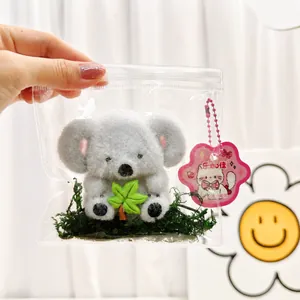 Koala themed decompression squishy toy in clear blind bag packaging with green moss
