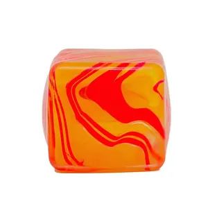 Primo piano del giocattolo antistress a cubetto di ghiaccio marmorizzato arancione e rosso.