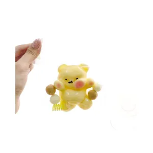 Adorable yellow bear squishy stress relief toy with soft pompoms and spring base