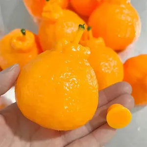 Close-up of handmade orange squeeze toy showing texture and hand-held size for stress relief