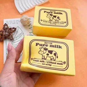 Close-up of yellow butter brick squishy toy showing its soft, slow rebound texture.