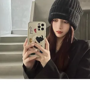 Lifestyle detail shot of a woman wearing a trendy black knitted beanie for winter warmth.