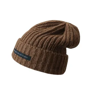 Cozy brown slouchy knit beanie for men and women, warm winter wool skull cap accessory.