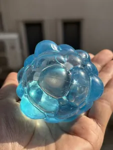 Close-up of a blue translucent snowflake ice cube squishy held in a person's hand