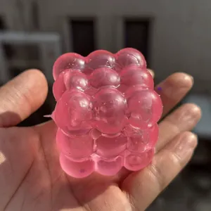 Pink translucent maltose cube squishy toy for stress relief and sensory fidget play
