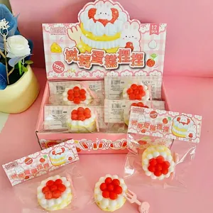 Detail view of colorful raspberry cake squishy fidget toys in retail display packaging