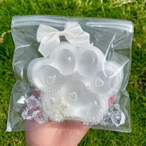 Close-up of a jumbo transparent cat paw squishy with pearl and snowflake details.