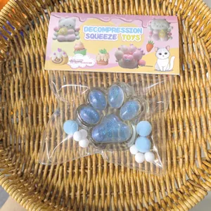 Detailed view of the blue transparent cat paw squishy toy in its cute retail packaging