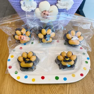Detailed view of Halloween cat paw squishy toys with spooky charms in clear packaging