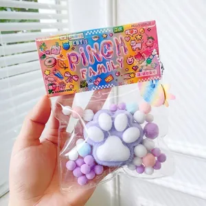 Detailed view of rainbow cat paw stress relief squishy toy in vibrant pixel art packaging