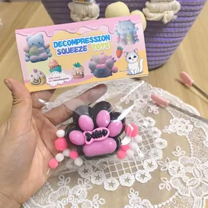 Cat paw decompression squeeze toy with pink pads and black base in clear package