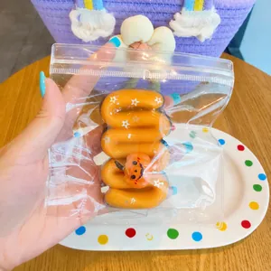 Close-up detail of a Halloween pumpkin squeeze toy inside a clear plastic zipper bag