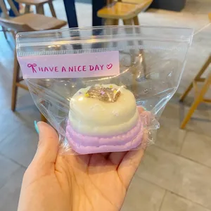 Detailed view of realistic Basque cheesecake squishy toy in cute packaging