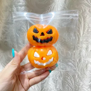 Detailed macro view of two stacked Halloween pumpkin squeeze toys in clear plastic bag