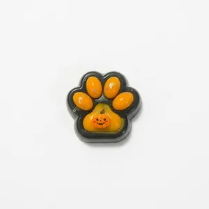 Halloween theme squishy toy featuring a black cat paw with orange pumpkin design for stress relief