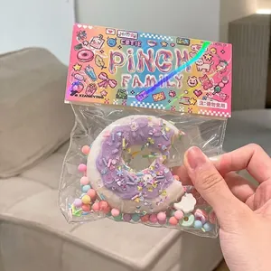 Detail shot of a purple donut-shaped TPR squishy toy in colorful retail packaging